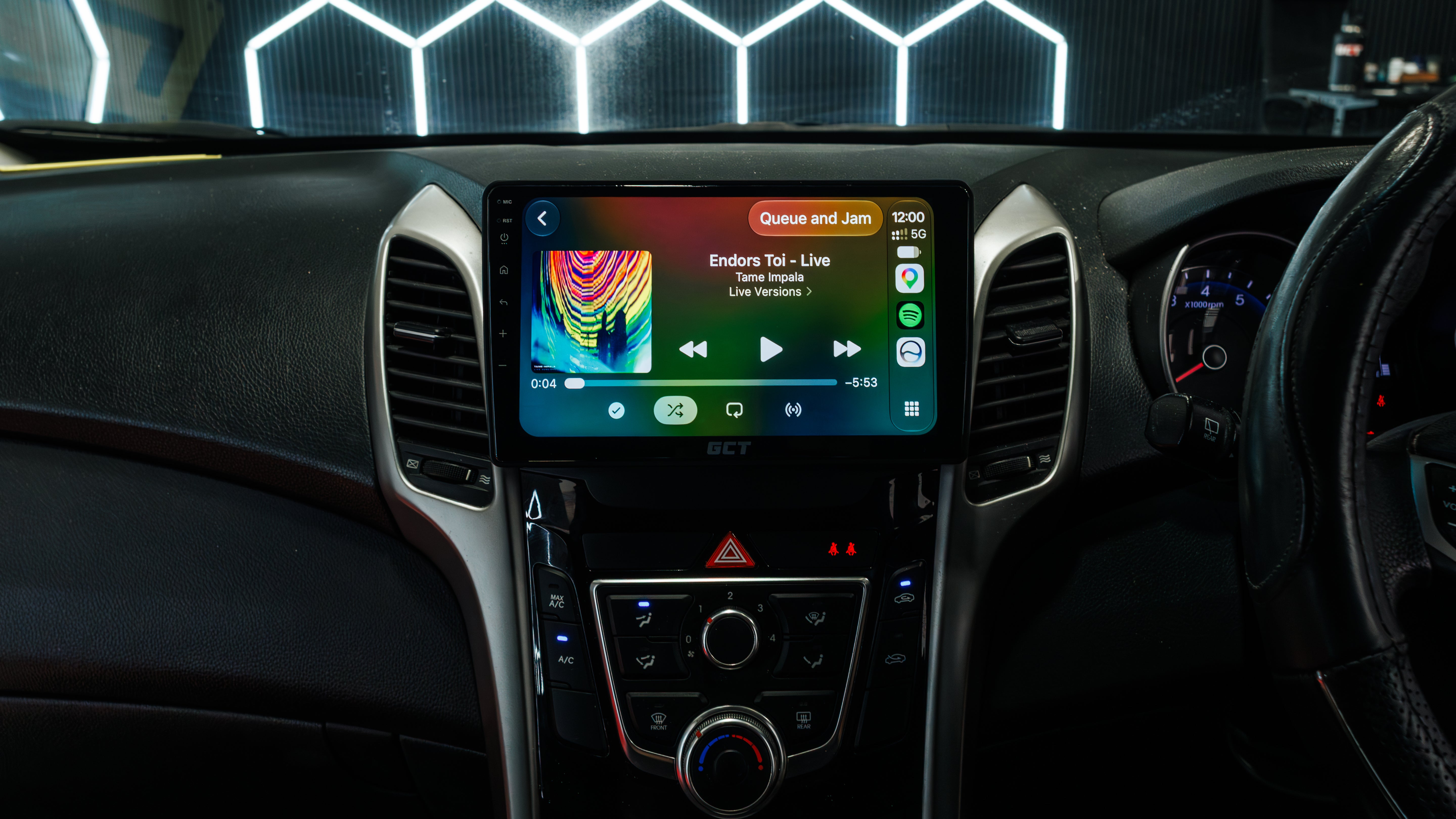 Htyundai i30 interior dashboard with a large touchscreen display showing media controls, mounted in the center console between air vents.